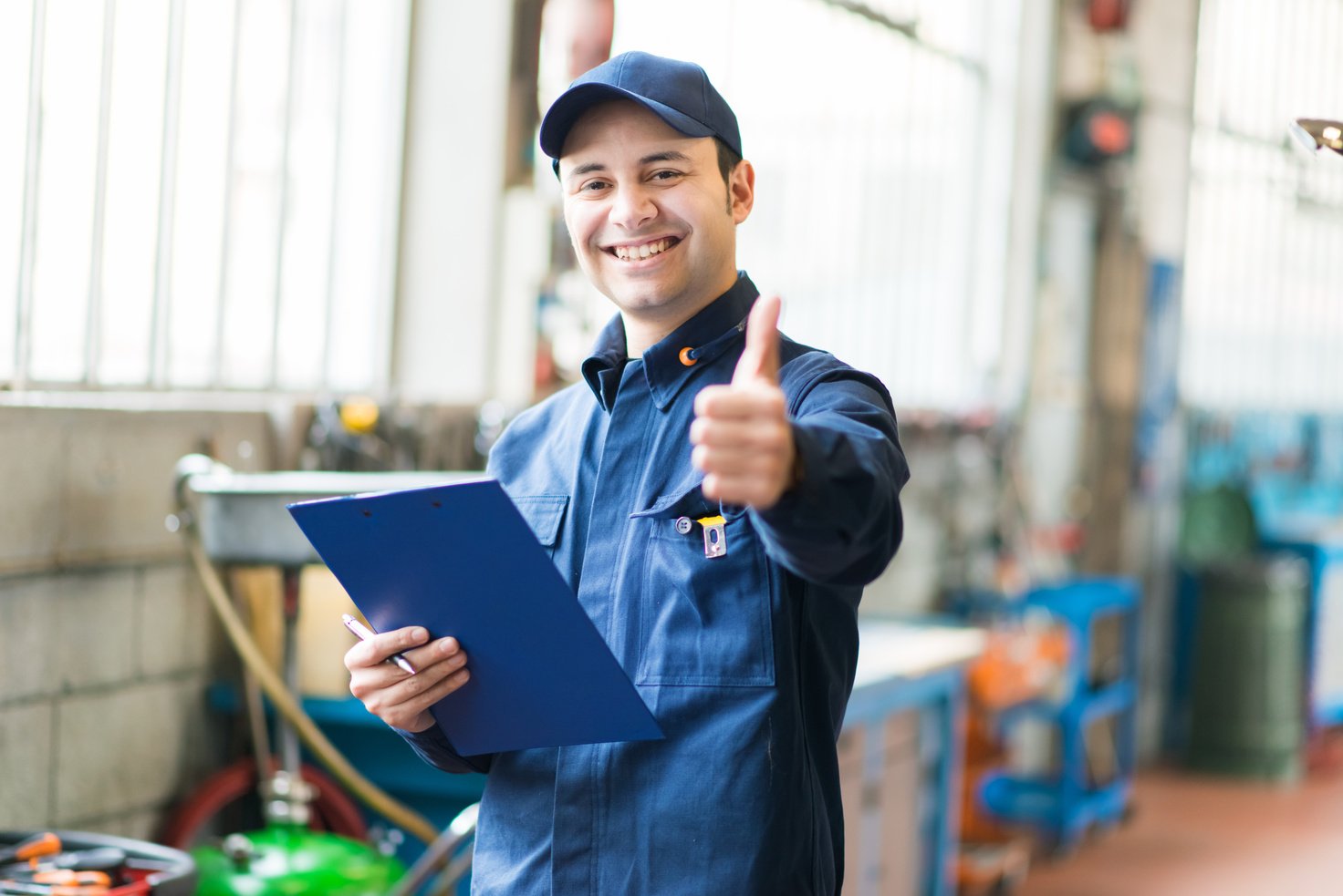 Smiling mechanic thumbs up